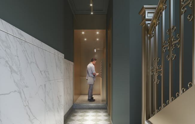 a man standing in a hallway with a door to a hotel room at East 4th Street, Ohio, 44115