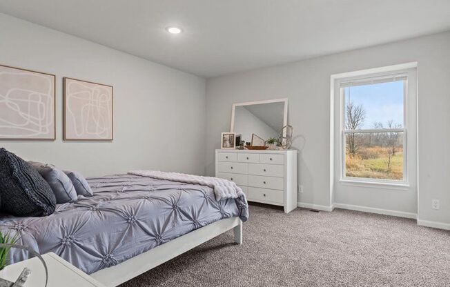 a bedroom with a bed and a dresser