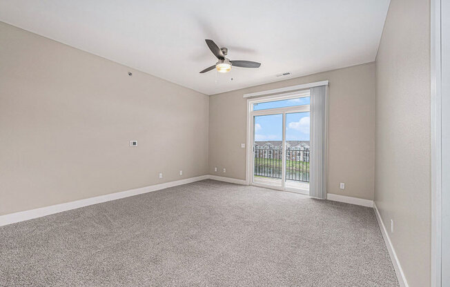 living room leading to a balcony at Trade Winds Apartment Homes, Elkhorn, NE