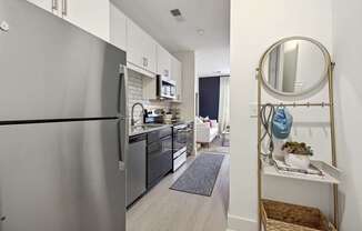 a kitchen with stainless steel appliances and a stainless steel refrigerator at Link Apartments® Calyx, North Carolina, 27517