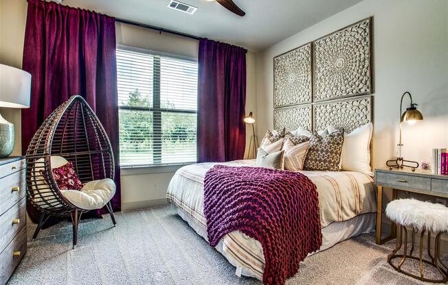 One Two and Three Bedroom Apartments in Grand Prairie, TX - Bedroom With Lush Carpeting, Large Window and Stylish Decor