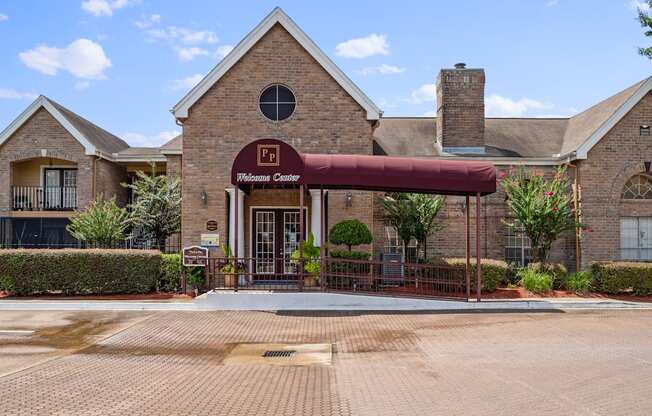 a brick building with a red awning in front of it