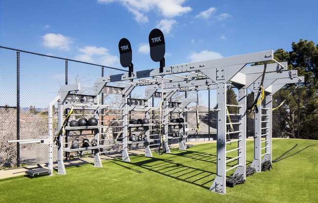 a gym with weights and equipment on a grass field