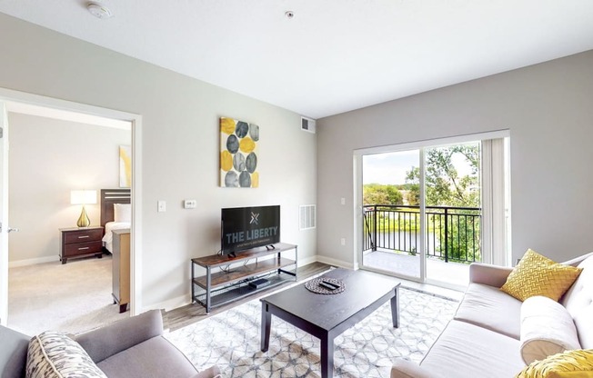 a living room with a couch and a coffee table and a tv