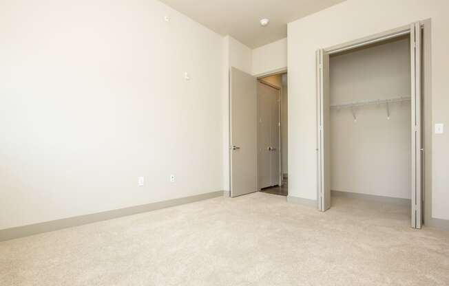 a empty room with a door to a closet