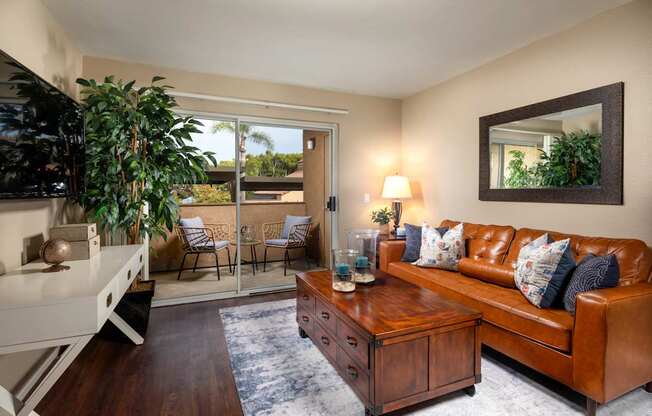 Living room with a brown leather couch and a coffee table