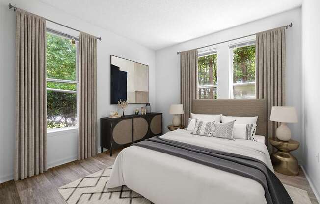 A bedroom with a large bed and a painting on the wall.