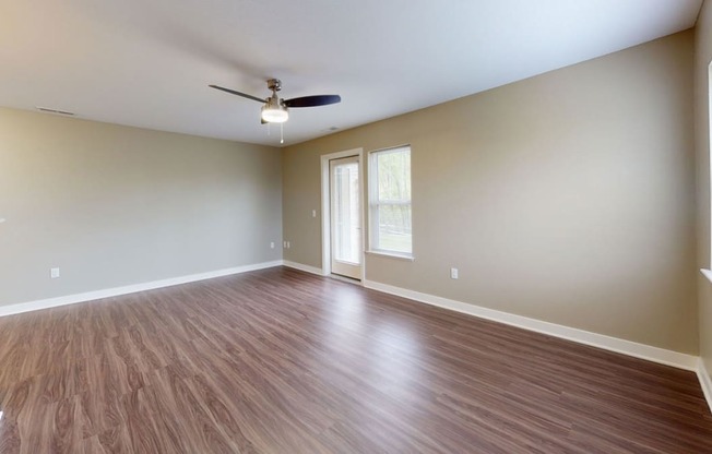 enlarged living room with extra windows and a ceiling fan