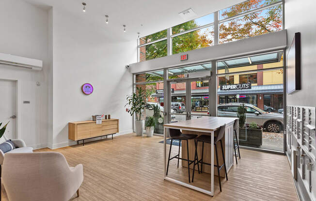 A room with a wooden floor and a table with chairs.