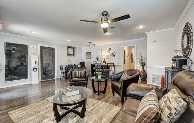 a living room filled with furniture and a ceiling fan