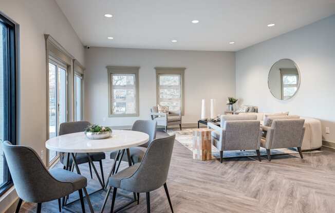 a dining room with a table and chairs and a living room