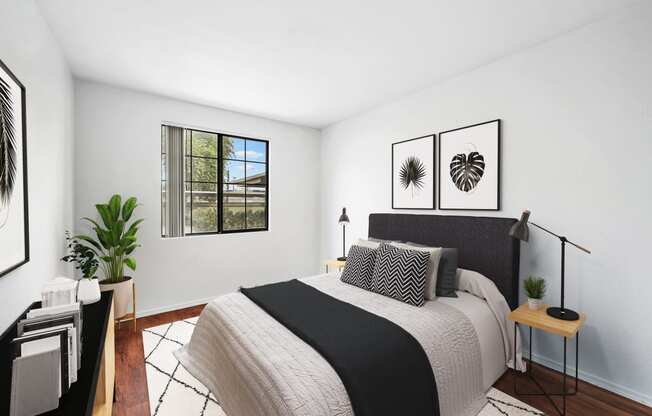 virtually staged bedroom with hardwood-style flooring and window