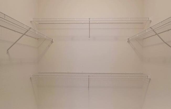 Empty white closet with three shelves.