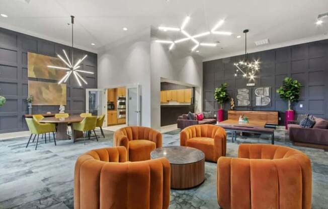 A modern living room with a grey wall and a large orange chair.