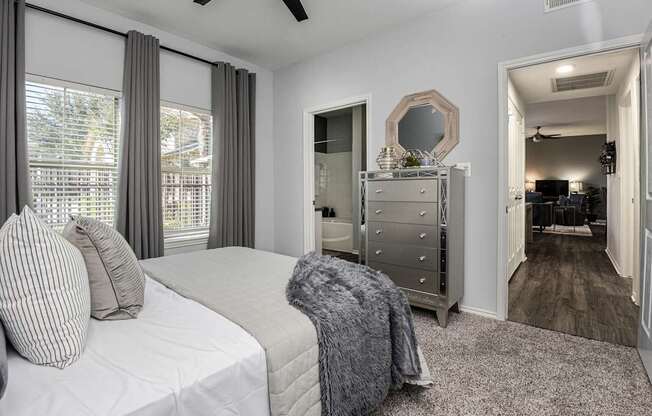 a bedroom with a bed and a dresser and a mirror