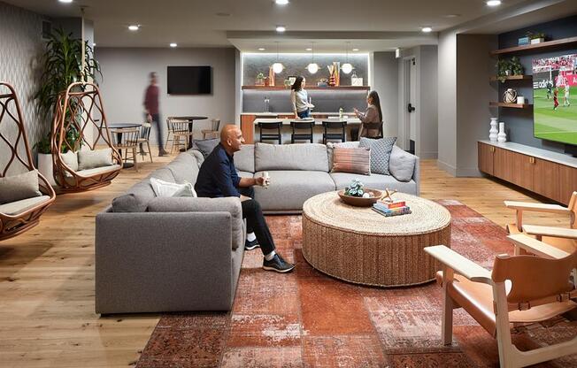 a man sitting on a couch in a living room