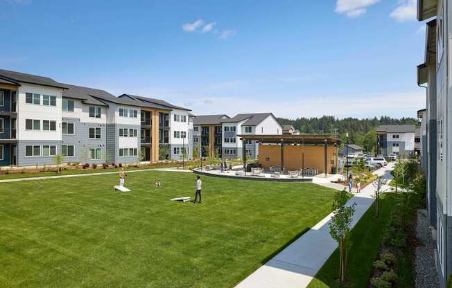 an aerial view of a grassy area with people playing frisbee