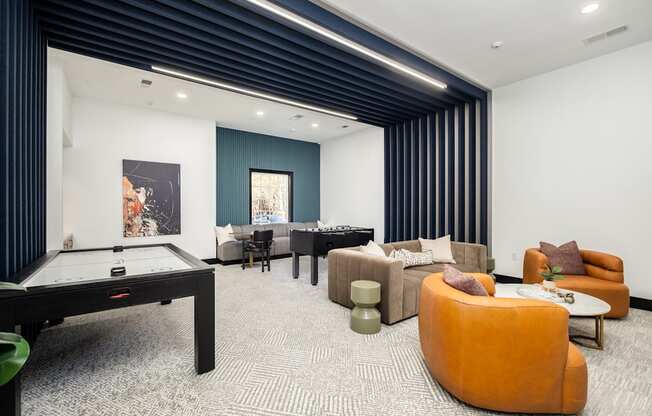 A room with a pool table and a couch.