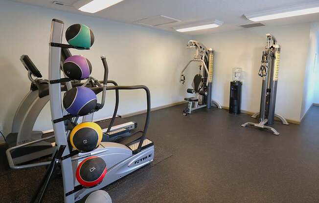 a gym with weights and other exercise equipment in a room