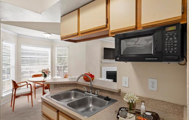 a kitchen with a sink and a microwave