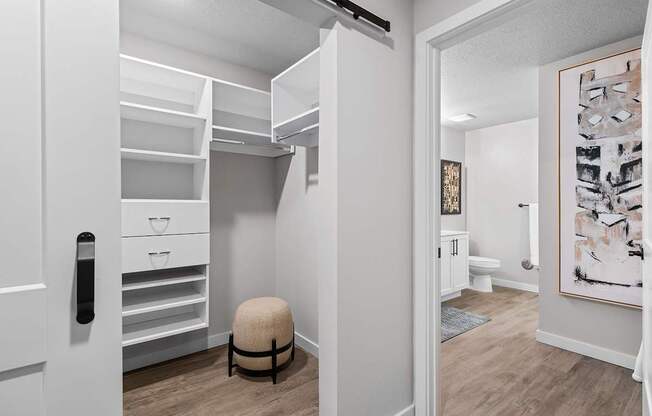 California-style walk-in closet and bathroom in model