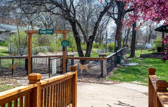 a park with a wooden fence and a bridge