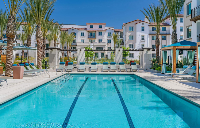 A large swimming pool in front of a resort.