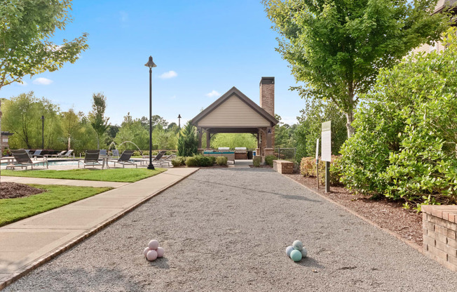 a pathway leading to a pavilion with balls on the ground