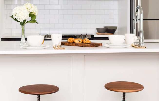 A kitchen with a white tile backsplash and a white fridge at The Pennsylvanian Apartments, Pennsylvania, 15222