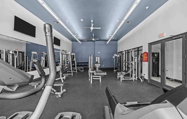 A gym with treadmills, elliptical machines, and other cardio equipment.