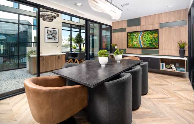 A modern dining room with a large table and chairs.
