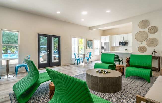 a living room with green chairs and a table