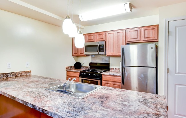 large kitchen with stainless steel appliances and large kitchen island at park vista apartments in washington dcl