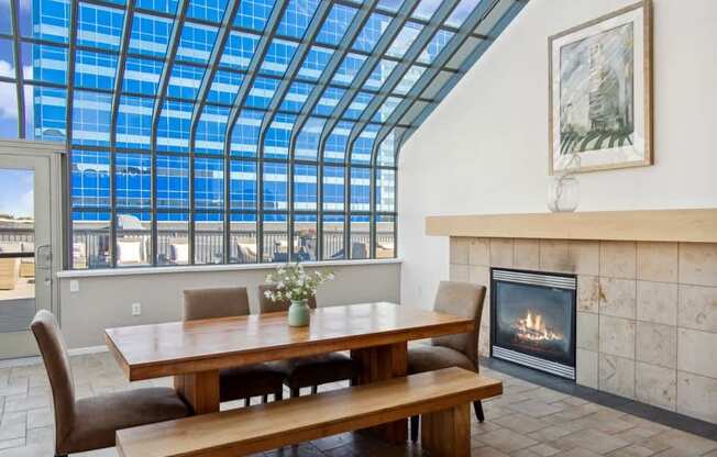 a room with a table and chairs and a fireplace