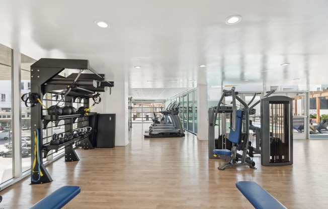 fitness center with strength training and cardio equipment at One Santa Fe apartments