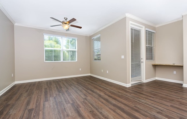 a bedroom with hardwood floors and a ceiling fan