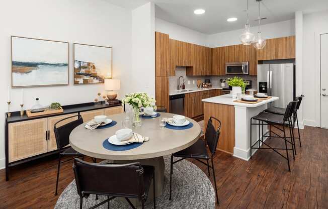 a dining room and kitchen with a table and chairs