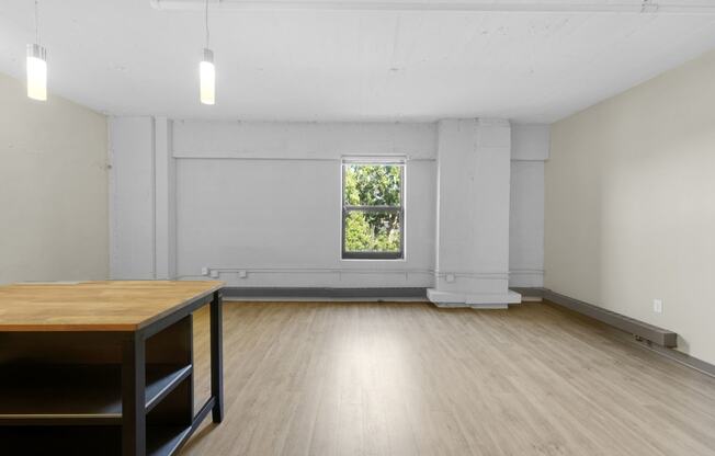 a room with hardwood floors and white walls