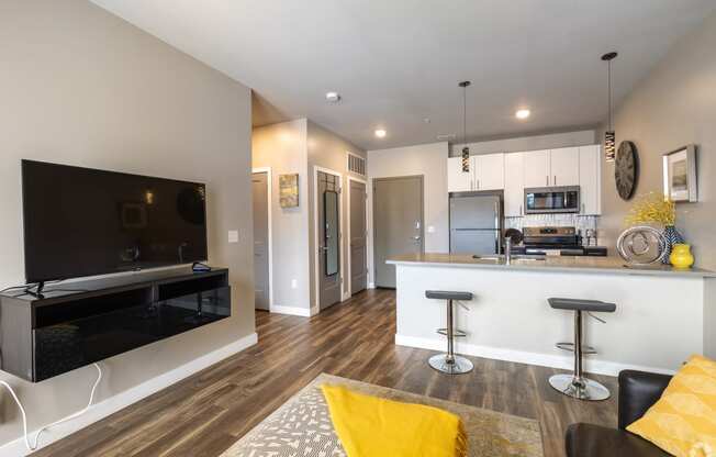 a living room with a kitchen and a television