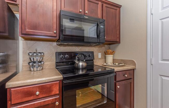 a stove top oven sitting inside of a kitchen