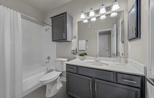 Bathroom with a shower and tub at Townhomes of Coyote Ridge