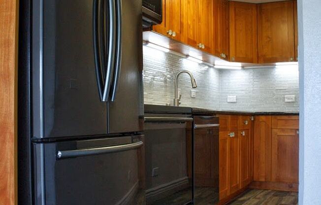 Napili Towers kitchen area with appliances, cabinets, and counters