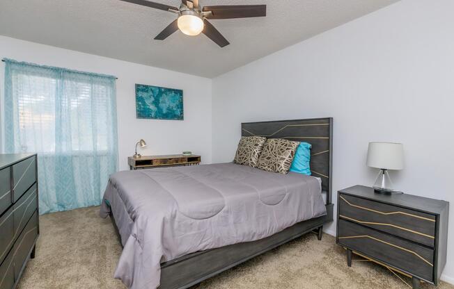 a bedroom with a bed and desk in a room