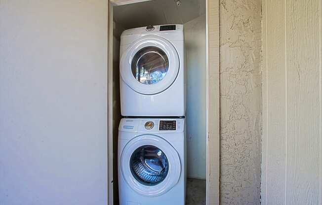 a washing machine and a dryer in a small closet