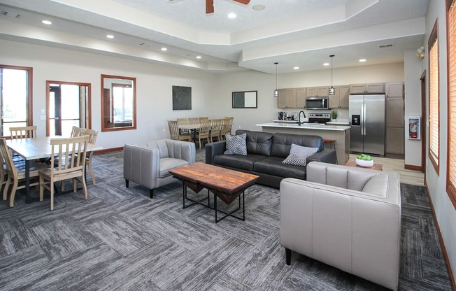 A modern living room with a grey carpet and furniture.