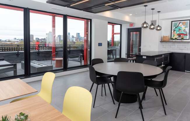 a dining room with a table and chairs and a view of the city