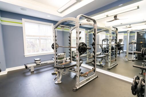 a gym with weights and other exercise equipment in a building at Merion Milford Apartment Homes, Connecticut