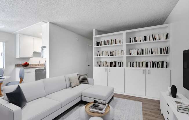 a living room with a white couch and a table