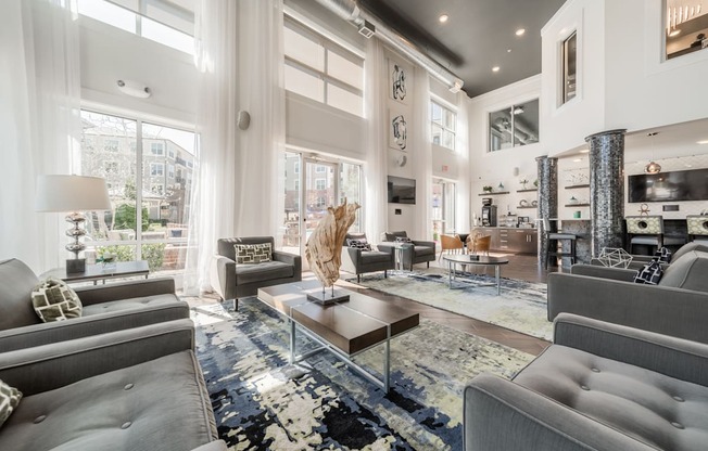 a living room filled with furniture and a large window
