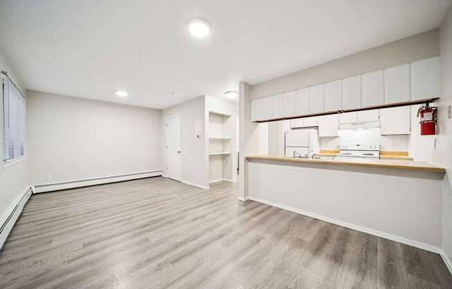 A room with a white wall and a wooden floor.